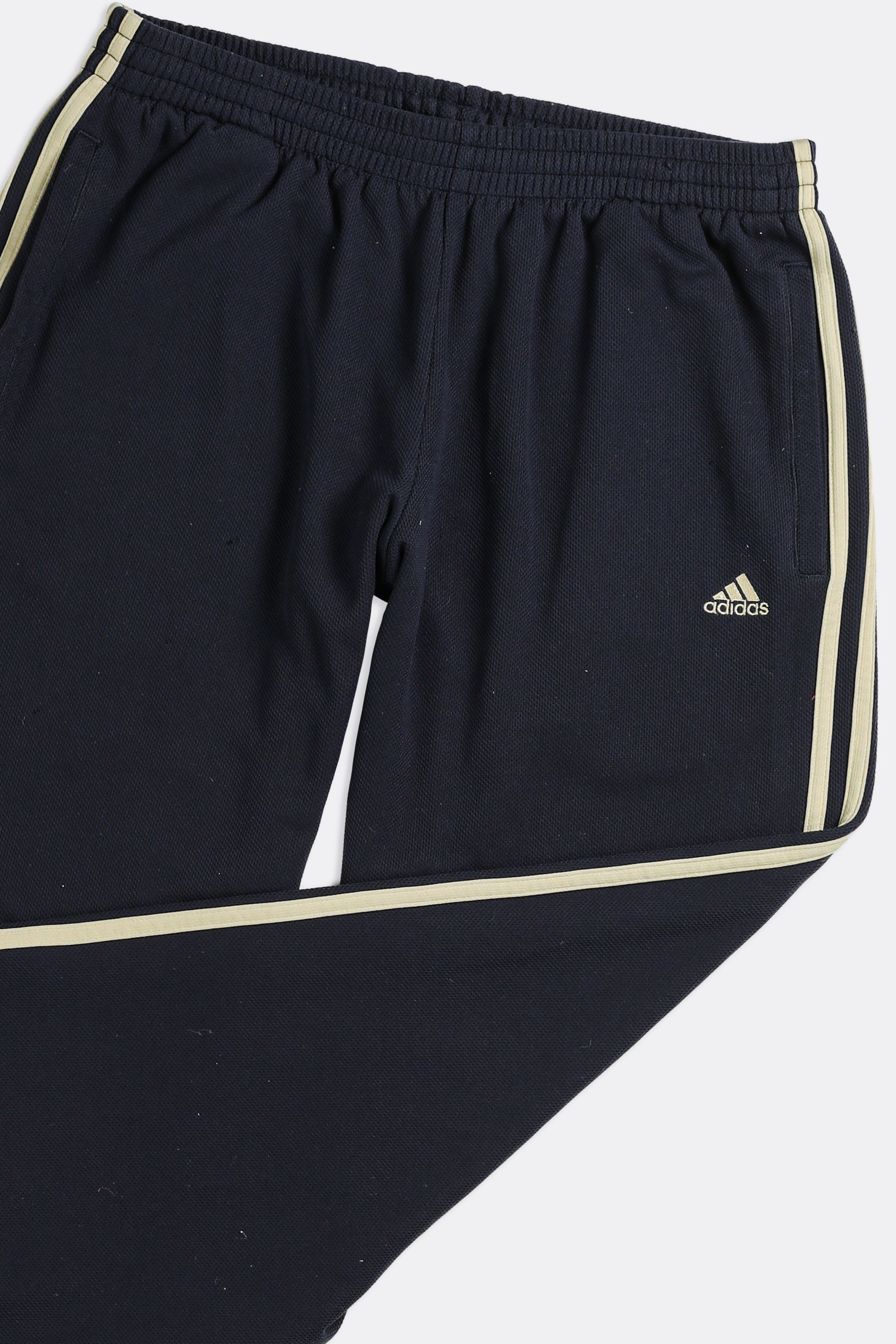 Adidas track pants hot sale gold stripes